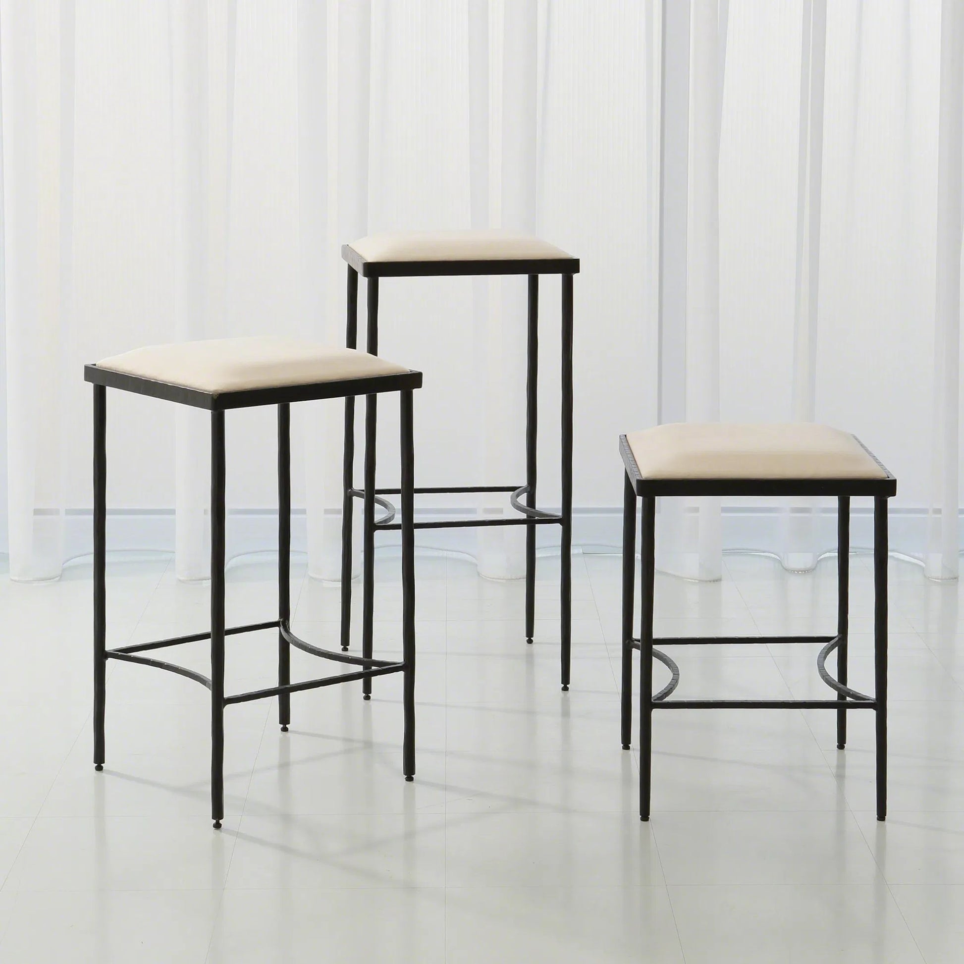 Hammered Bar Stool by Global Views. Made from iron in a modern style.