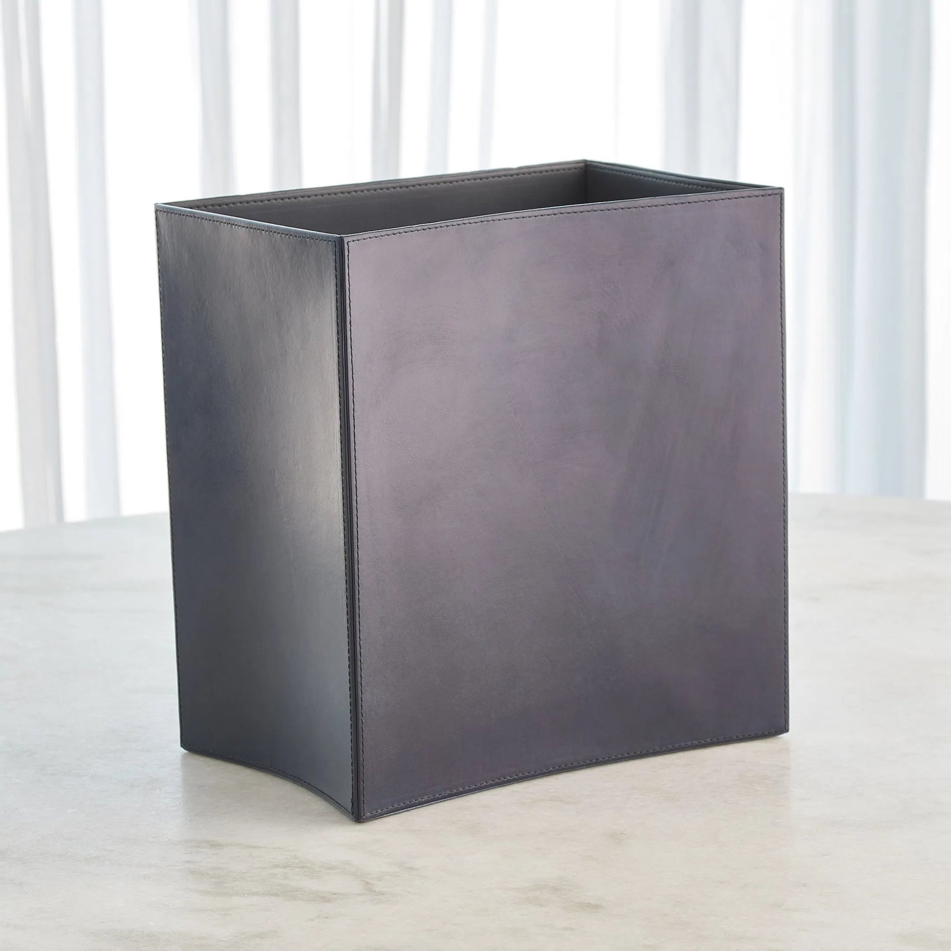 Folded Leather Wastebasket by Global Views. Made from leather in a modern style.