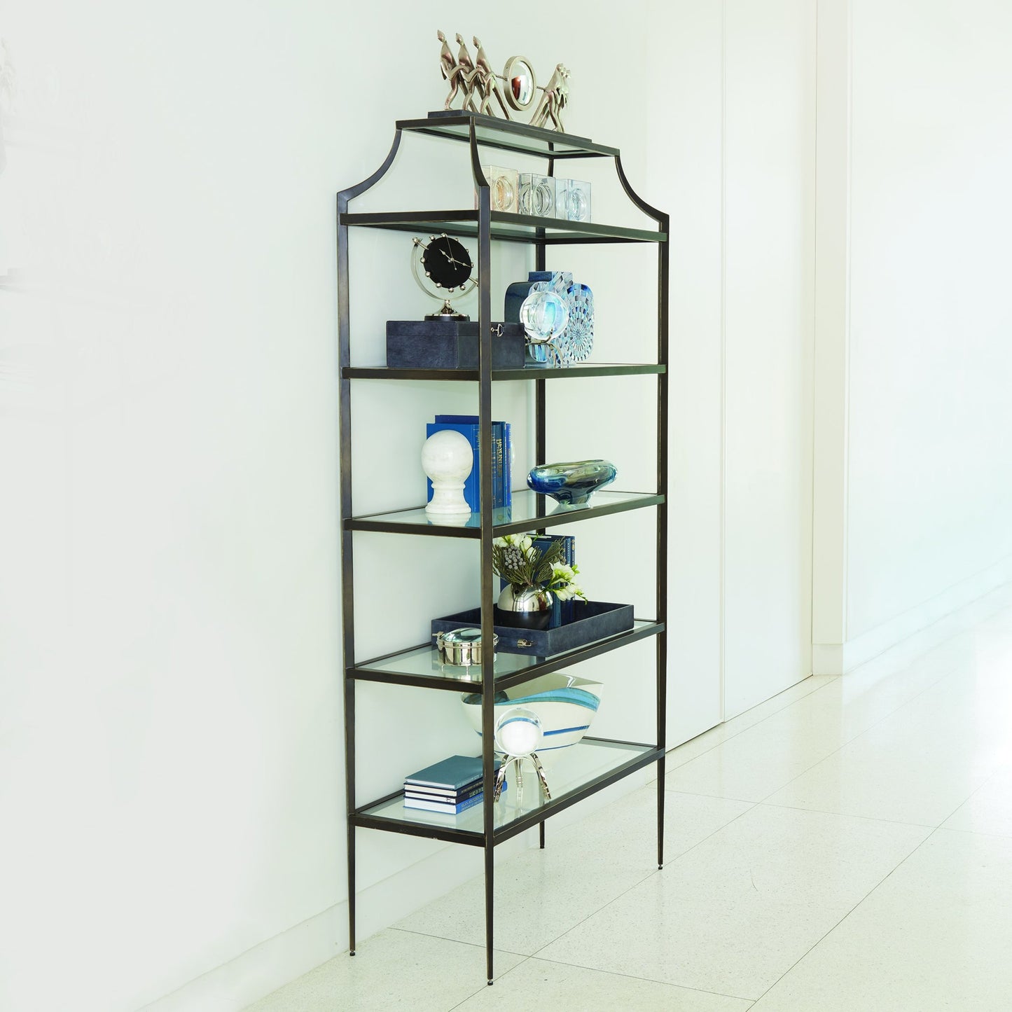 002 SR-701530 | Lifestyle | Lescot Etagere by Global Views in dark gunmetal bronze powder coat, gold edges, highlights. Made from iron, tempered glass in a transitional style.