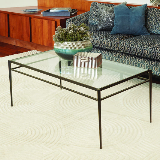 Lescot Cocktail Table by Global Views in dark gunmetal bronze powder coat, gold edges, highlights. Made from iron, tempered glass in a modern style.