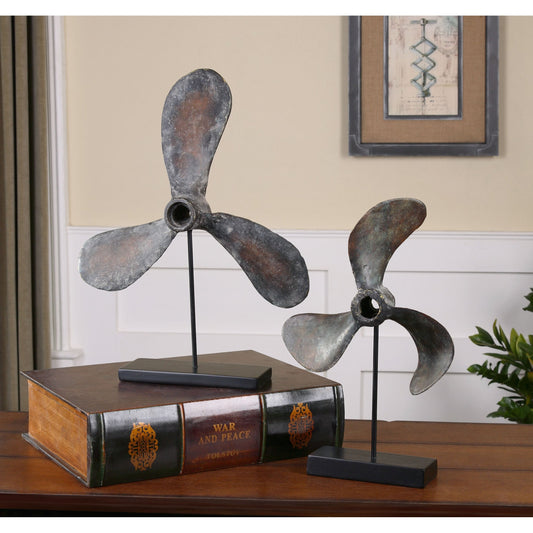 Propellers Rust Sculptures (Set of 2) by Uttermost in rust. Made from resin, metal in a cottage & farmhouse style.