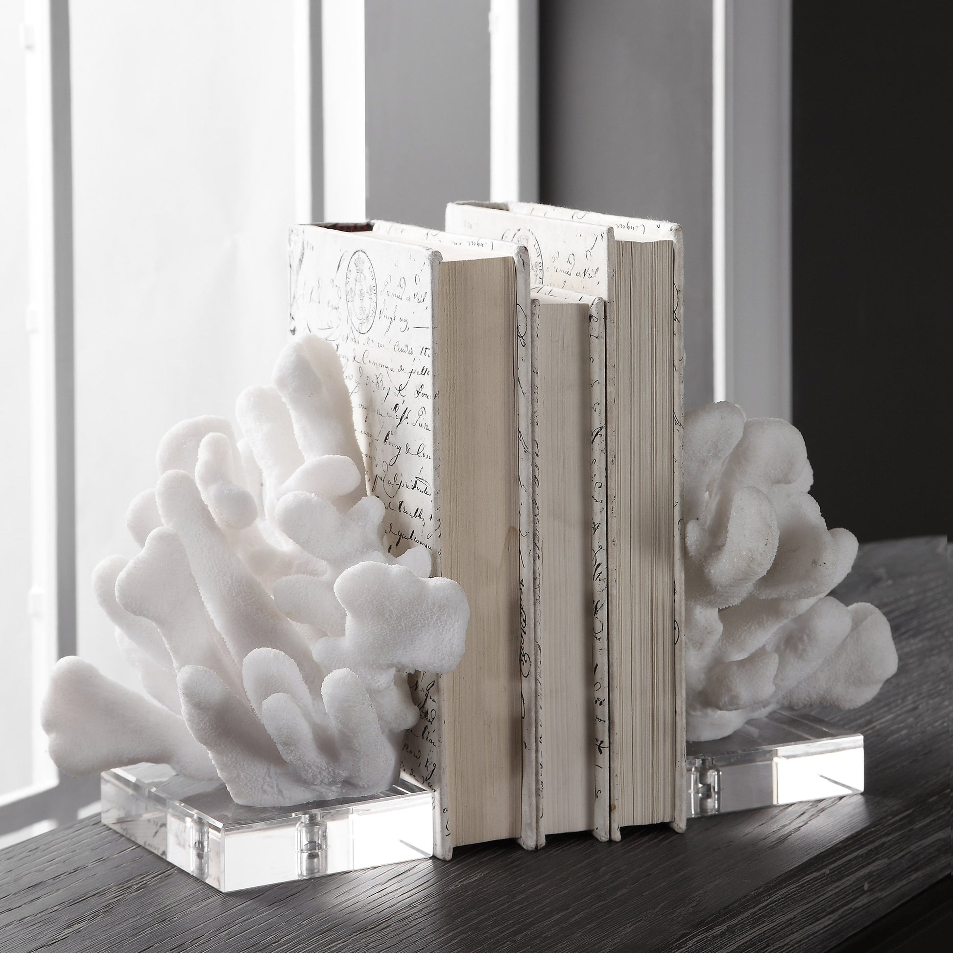Charbel Bookends by Uttermost in white. Made from resin, k9cystal in a coastal style.