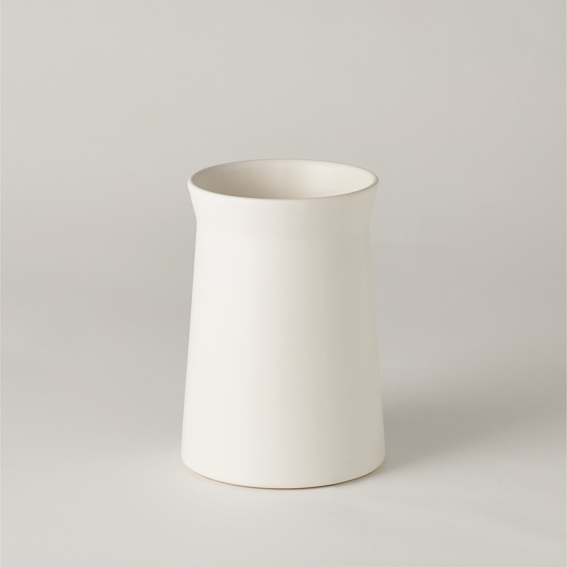 Soft Curve Vase by Global Views in white. Made from ceramic in a modern style.