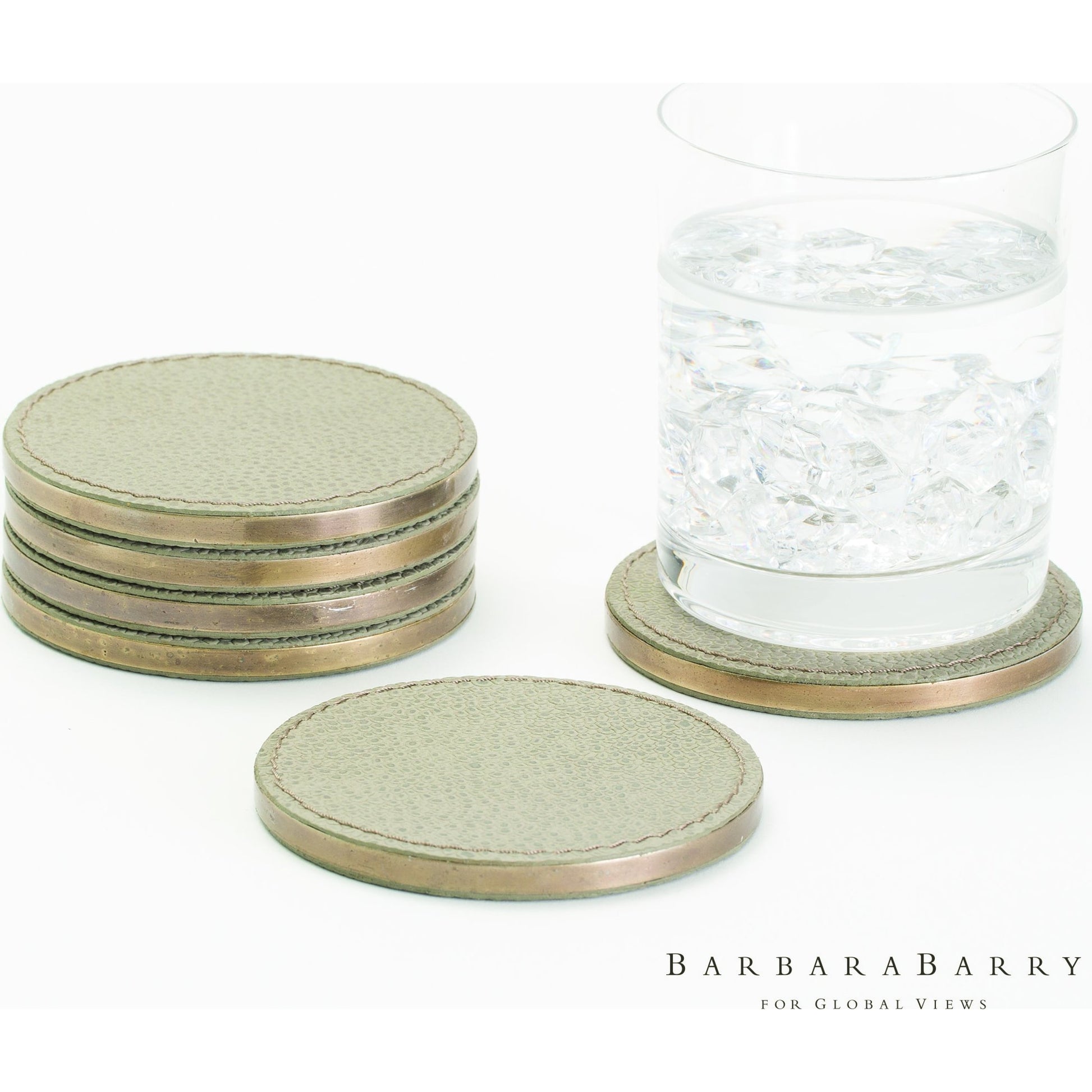 Alpen Coasters by Global Views. Made from mdf, brass, leather, polyester suede in a transitional style.