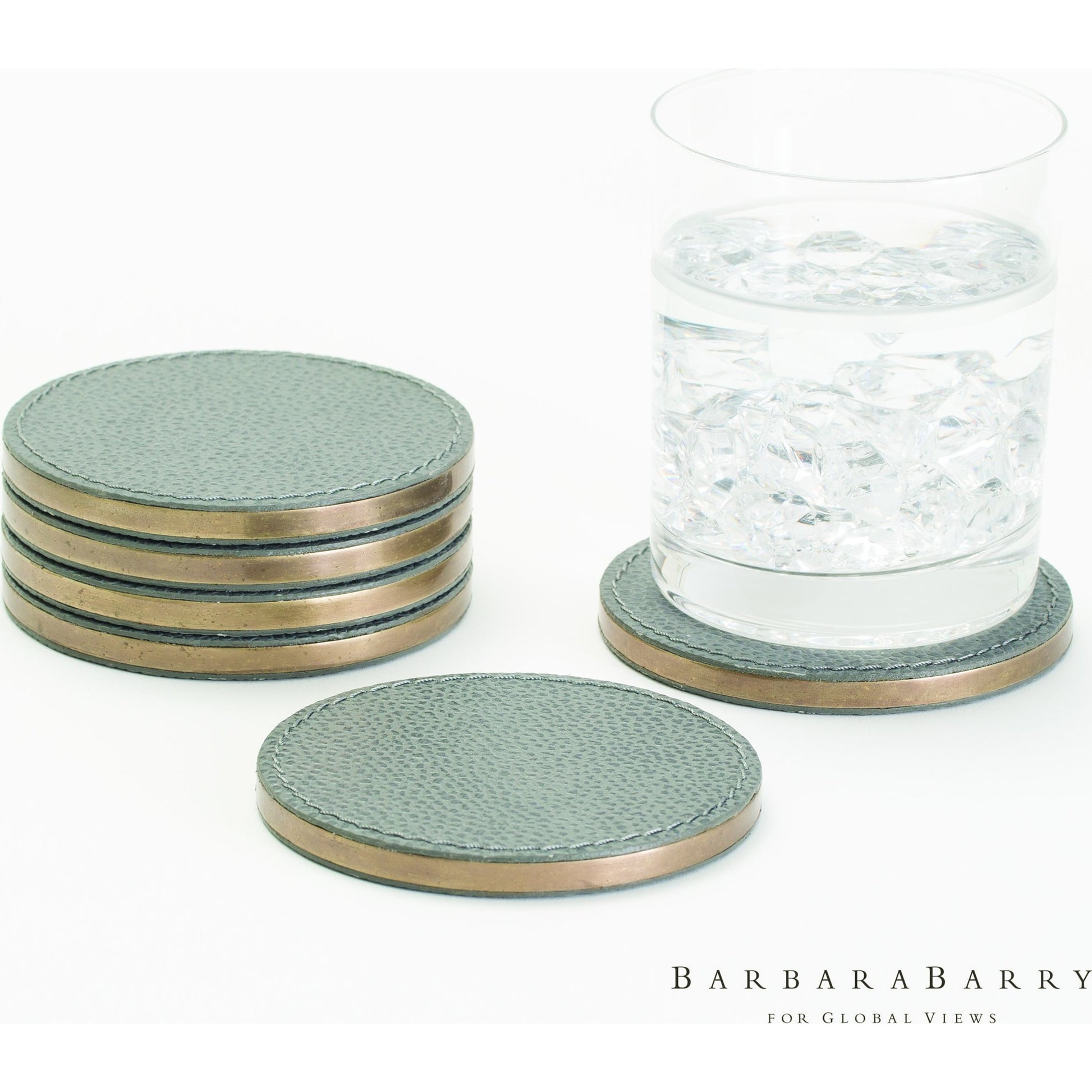 Alpen Coasters by Global Views. Made from mdf, brass, leather, polyester suede in a transitional style.