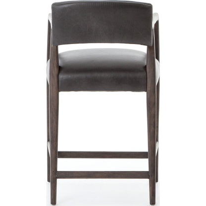 Tyler Counter Stool by Four Hands in chaps ebony, burnt oak. Made from top grain leather, solid nettlewood, 100% polyester in a modern style.