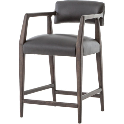 Tyler Counter Stool by Four Hands in chaps ebony, burnt oak. Made from top grain leather, solid nettlewood, 100% polyester in a modern style.