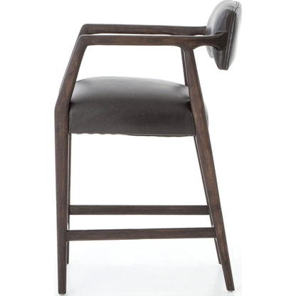 Tyler Counter Stool by Four Hands in chaps ebony, burnt oak. Made from top grain leather, solid nettlewood, 100% polyester in a modern style.