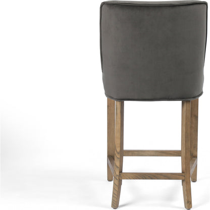 Aria Counter Stool by Four Hands in sienna chestnut. Made from top grain leather, solid nettlewood, 100% polyester in a modern style.
