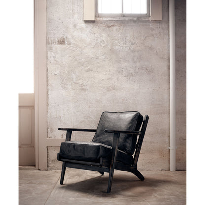 Brooks Lounge Chair by Four Hands in rialto ebony, black wash. Made from top grain leather, solid oak, 67% cotton, 33% flax, linen in a modern style.
