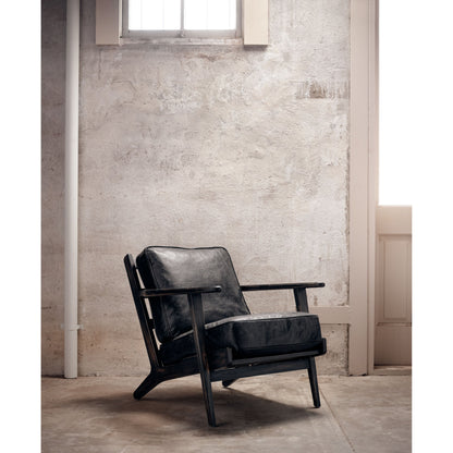 Brooks Lounge Chair by Four Hands in rialto ebony, black wash. Made from top grain leather, solid oak, 67% cotton, 33% flax, linen in a modern style.