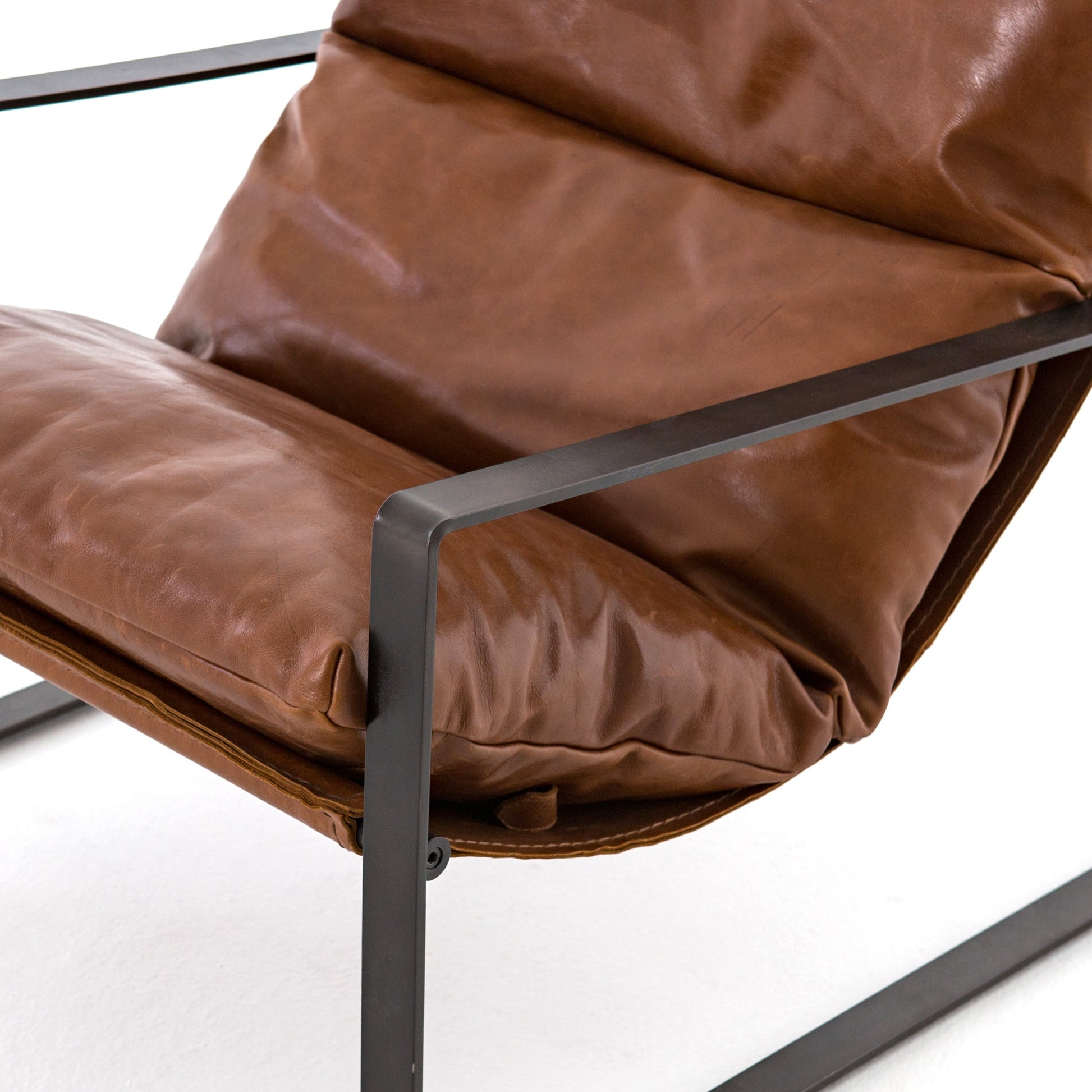 Emmett Sling Chair by Four Hands. Made from top grain leather, iron, 100% polyester in a modern style.