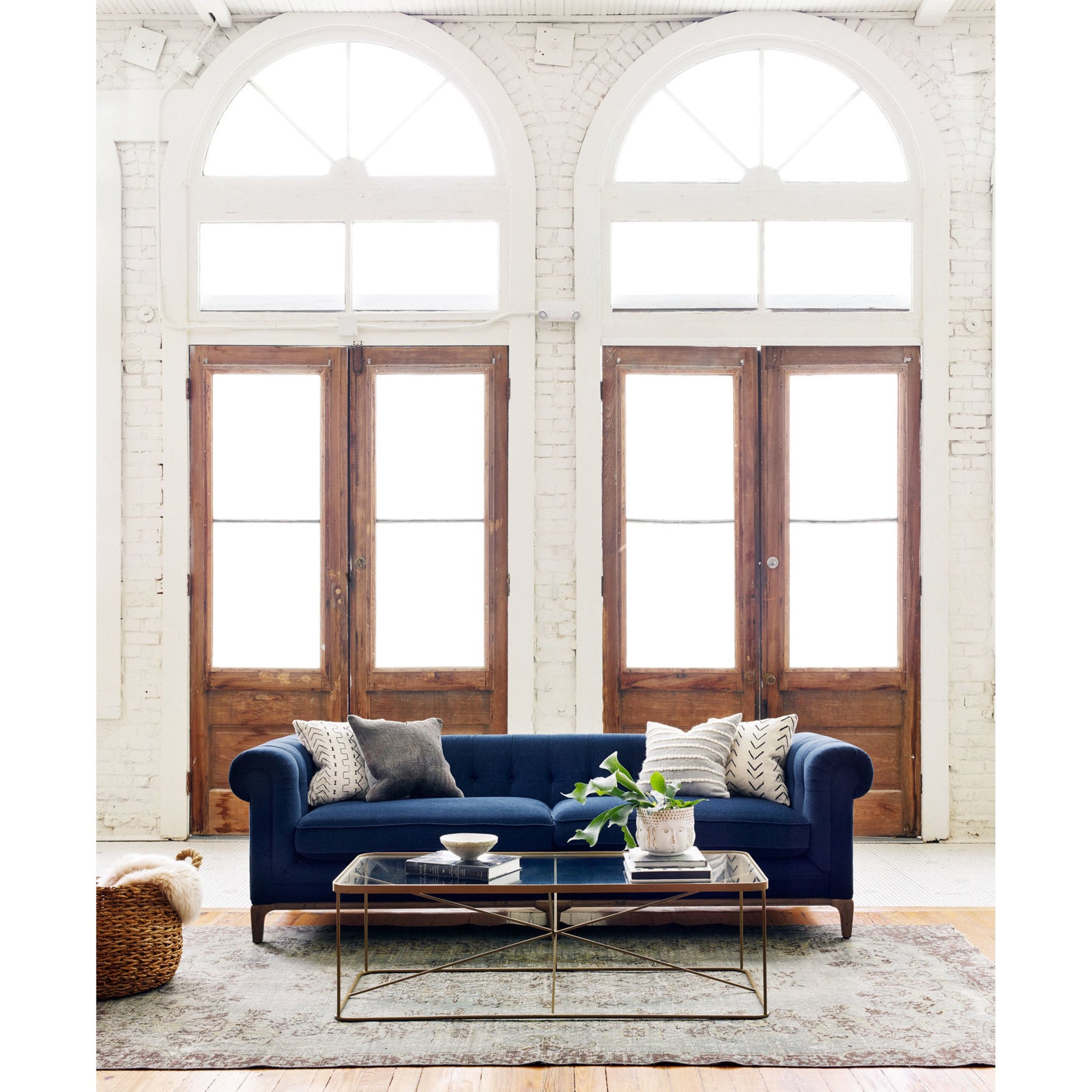 Griffon Sofa by Four Hands in plush navy and plush navy, antique walnut. Made from 100% polyester, solid parawood in a modern style.