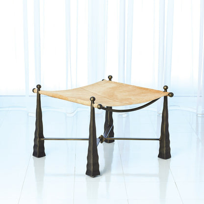 Cognac Ottoman by Global Views. Made from metal, cowhide in a rustic style.