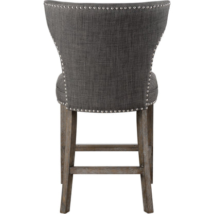 Arnaud Charcoal Counter Stool by Uttermost in charcoal. Made from solid wood, plywood, fabric, foam in a cottage & farmhouse style.
