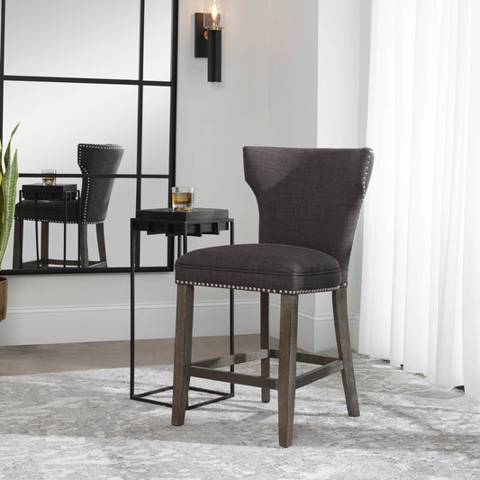 Arnaud Charcoal Counter Stool by Uttermost in charcoal. Made from solid wood, plywood, fabric, foam in a cottage & farmhouse style.