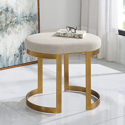 Infinity Accent Stool by Uttermost in gold. Made from metal, mdf, foam, fabric in a modern style.