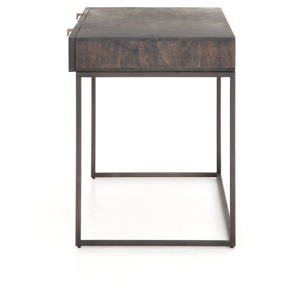 Kelby Writing Desk by Four Hands in aged brass, carved vintage brown, vintage brown, gunmetal and vintage brown. Made from solid mango, iron in a modern style.