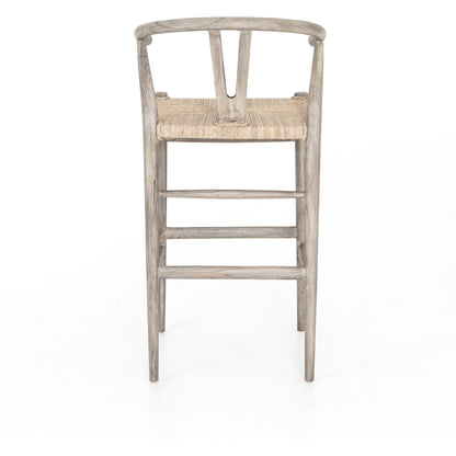 Muestra Bar Stool by Four Hands in vintage white, natural teak. Made from solid teak, 100% polyethylene in a coastal style.