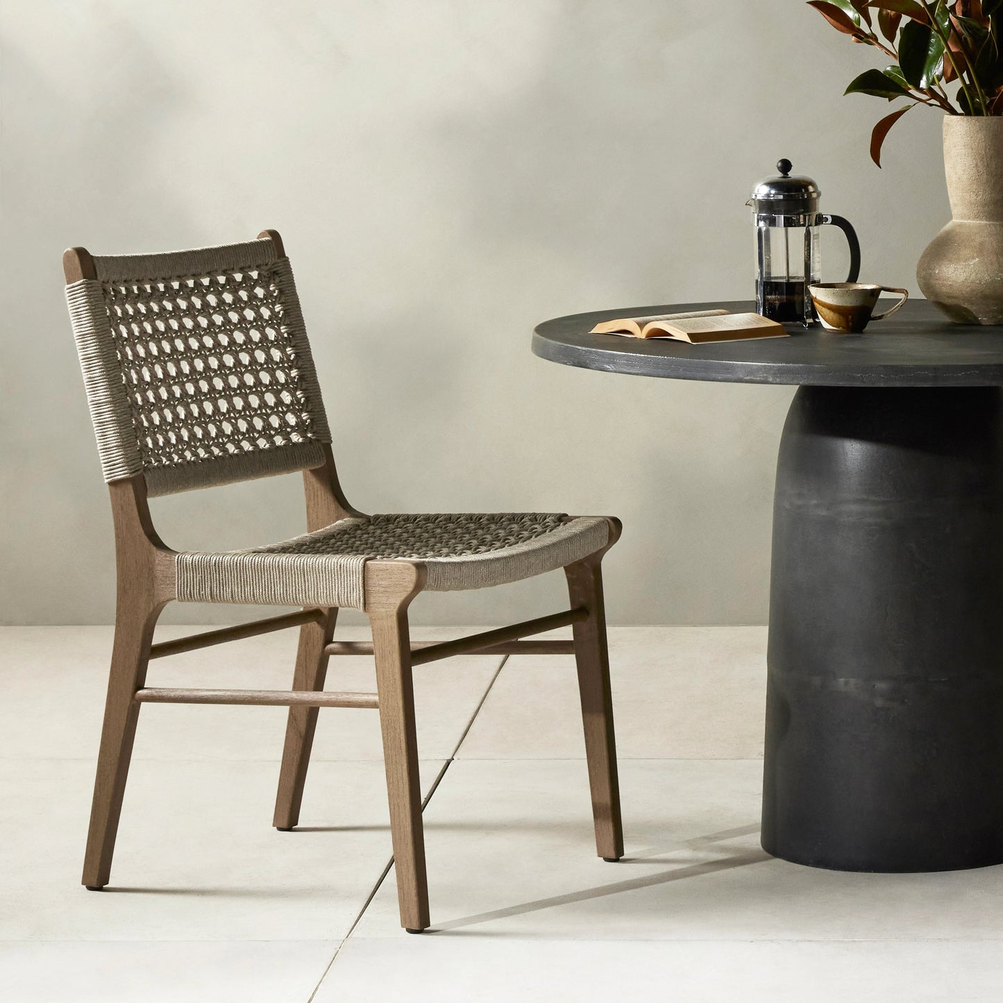 023 SR-809858 | Lifestyle | Delmar Outdoor Dining Chair by Four Hands. Made from solid fsc®-certified teak, 100% polypropylene in a cottage & farmhouse style.