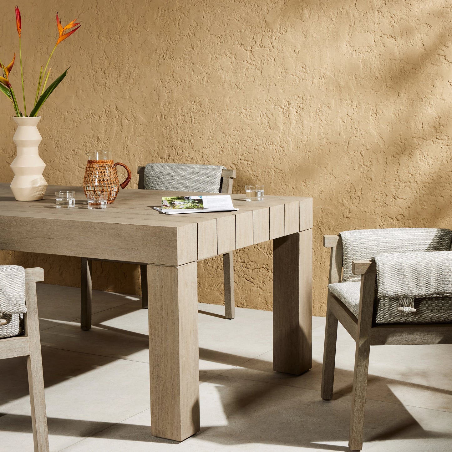 018 SI-1716798 | Lifestyle | Sonora Outdoor Dining Table by Four Hands in weathered grey. Made from solid teak in a modern style.