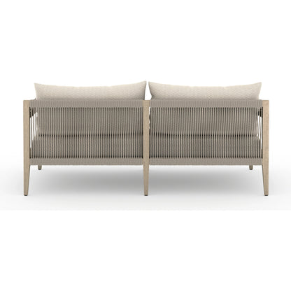 Sherwood Outdoor Sofa, Washed Brown by Four Hands. Made from 100% olefin, solid fsc®-certified teak, 100% polypropylene in a coastal style.