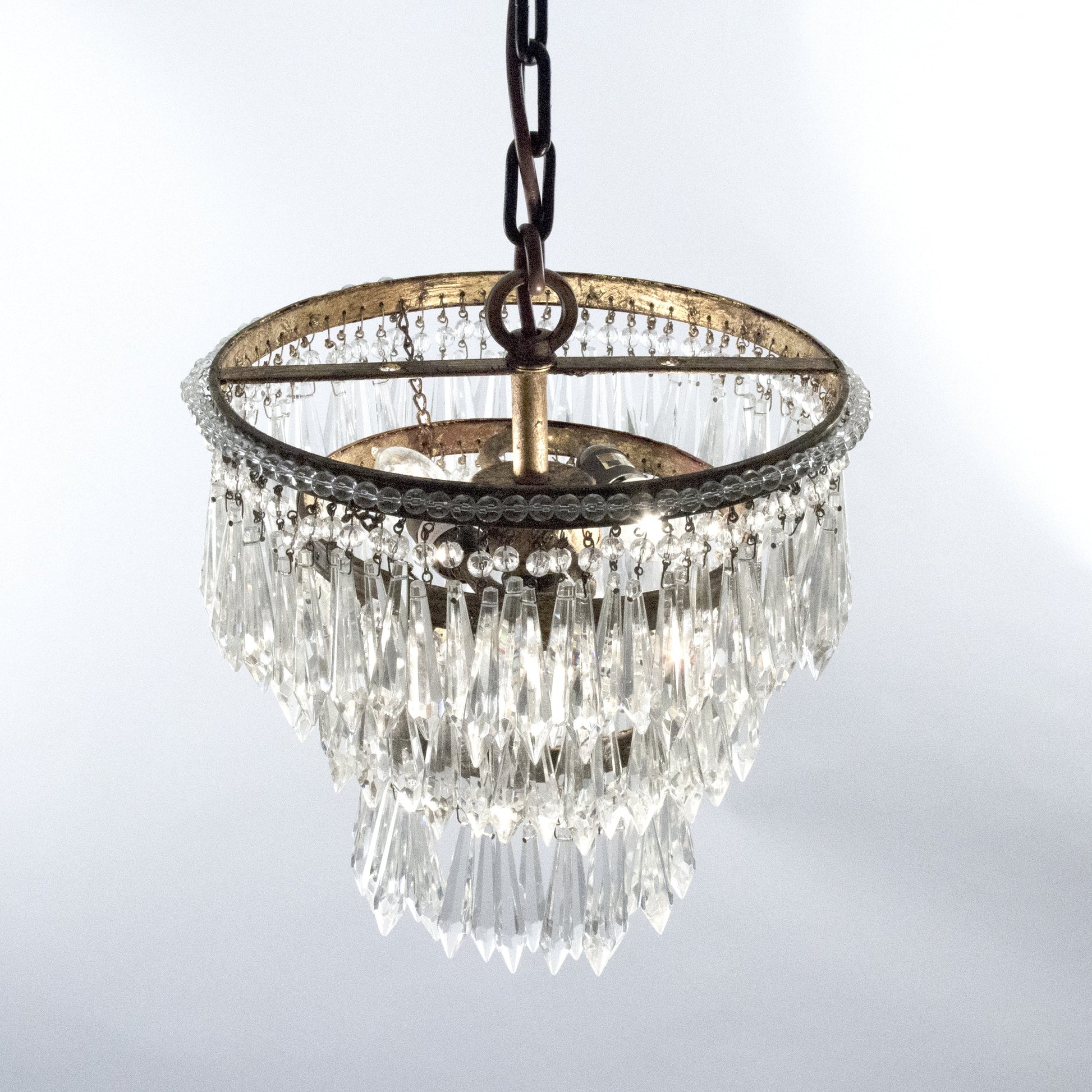 Ancil Chandelier by Zentique in copper hardware and crystal, copper. Made from crystal, copper in a traditional style.
