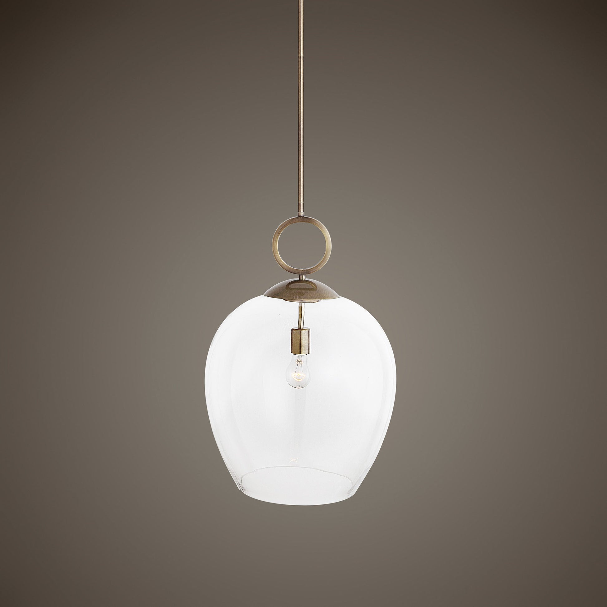 Calix Pendant by Uttermost in aged brass. Made from steel, glass in a transitional style.