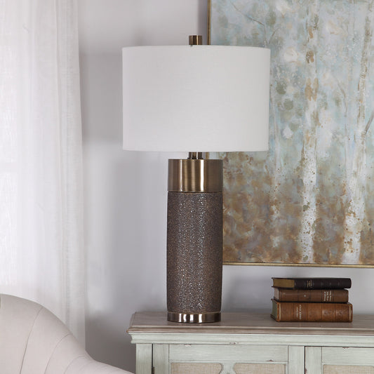 Brannock Table Lamp by Uttermost in bronze. Made from iron, ceramic, fabric in a transitional style.
