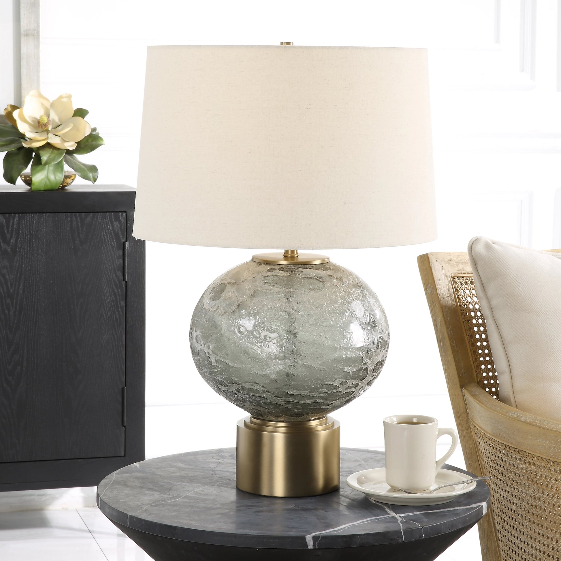Lunia Table Lamp by Uttermost in smoky gray. Made from iron, glass, linen in a modern style.