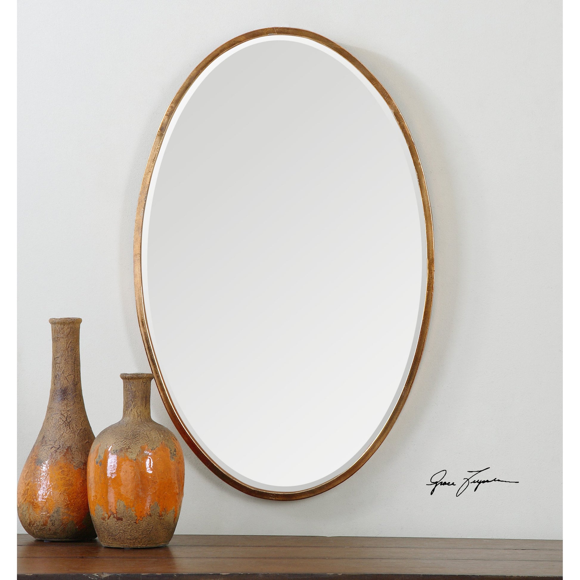 Herleva Mirror by Uttermost in gold. Made from metal in a modern style.
