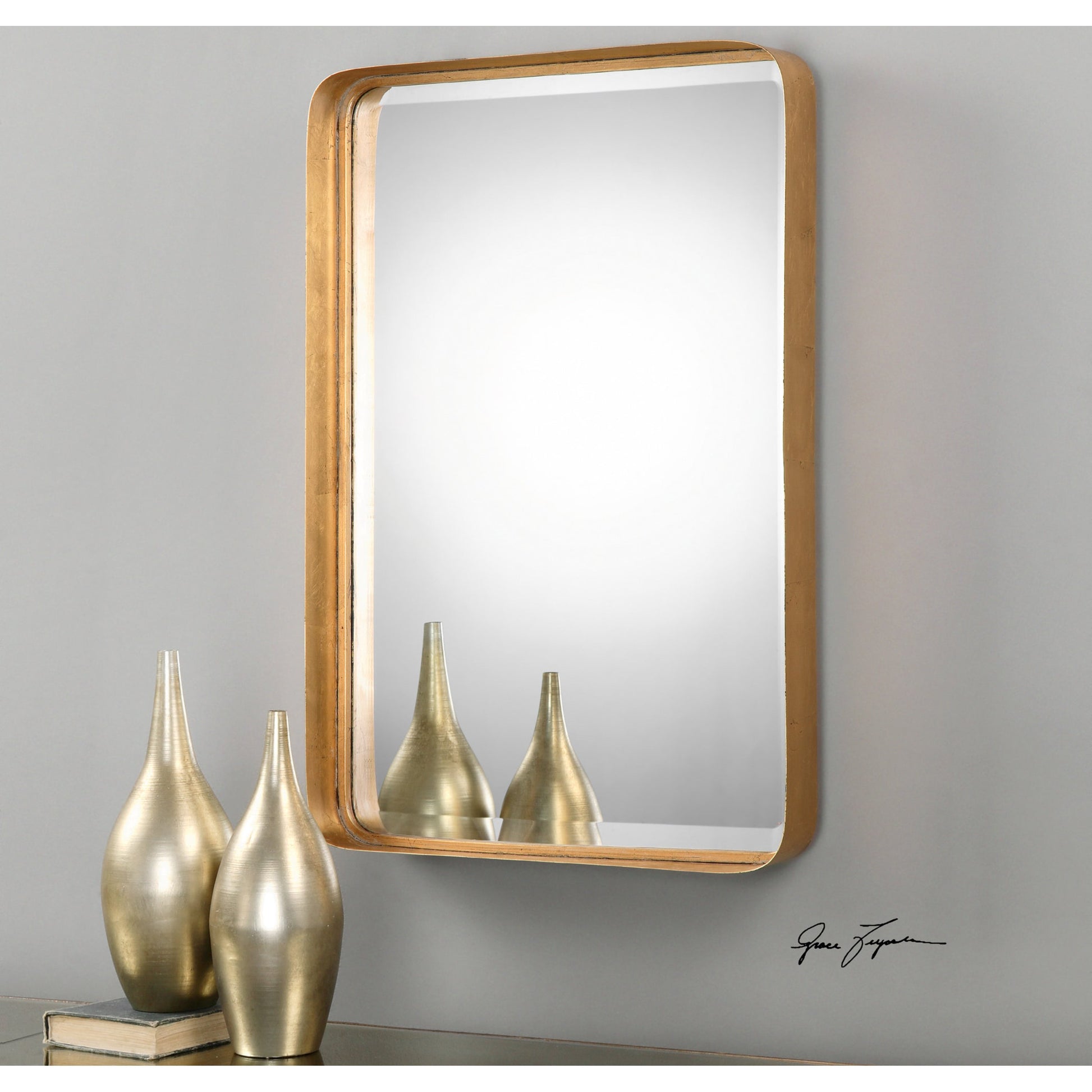 Crofton Vanity Mirror by Uttermost in gold. Made from metal in a modern style.