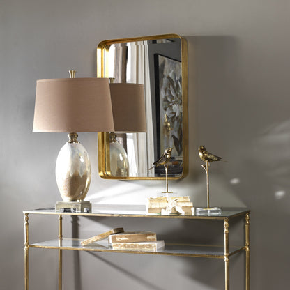 Crofton Vanity Mirror by Uttermost in gold. Made from metal in a modern style.