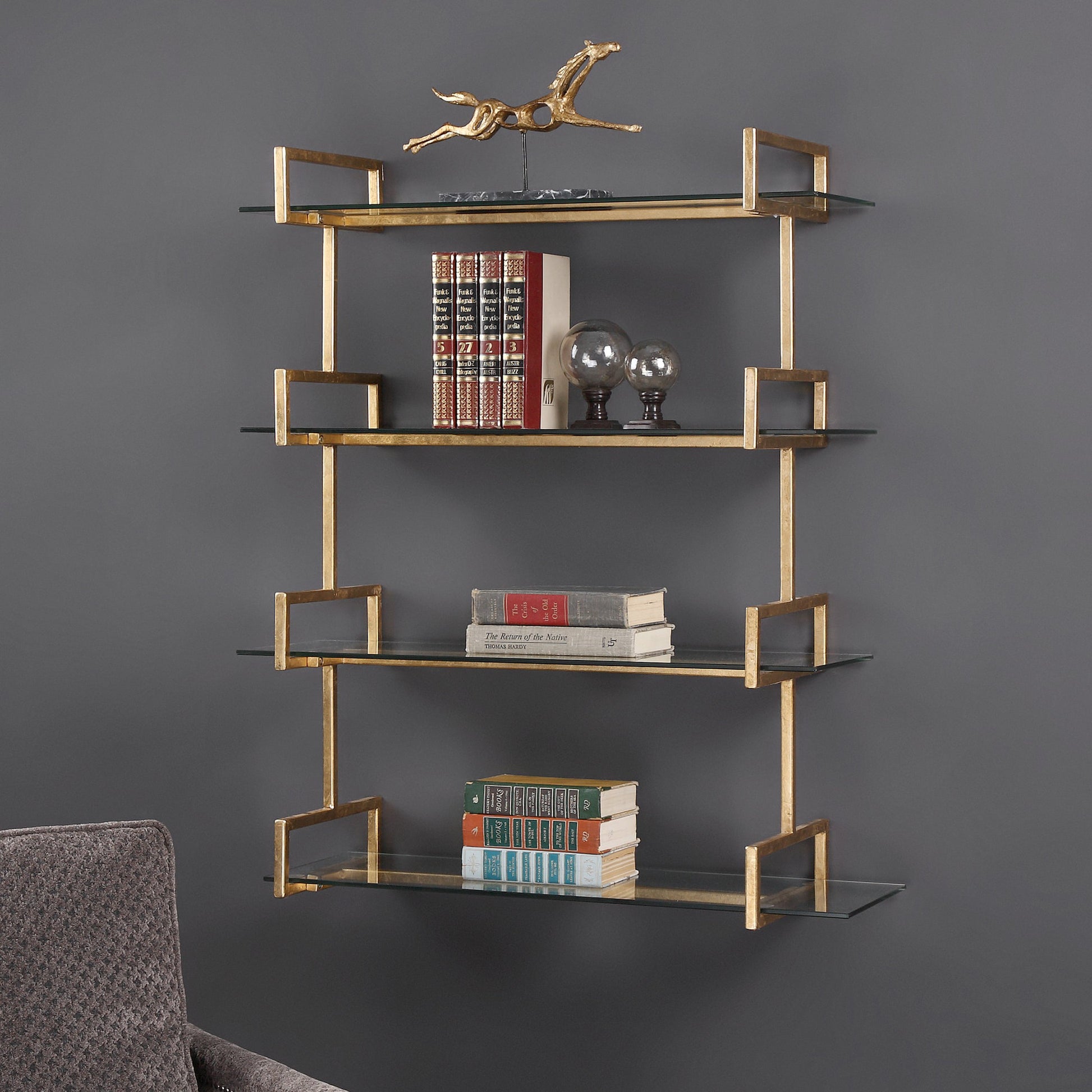 Auley Wall Shelf by Uttermost in gold. Made from iron, tempered glass in a modern style.
