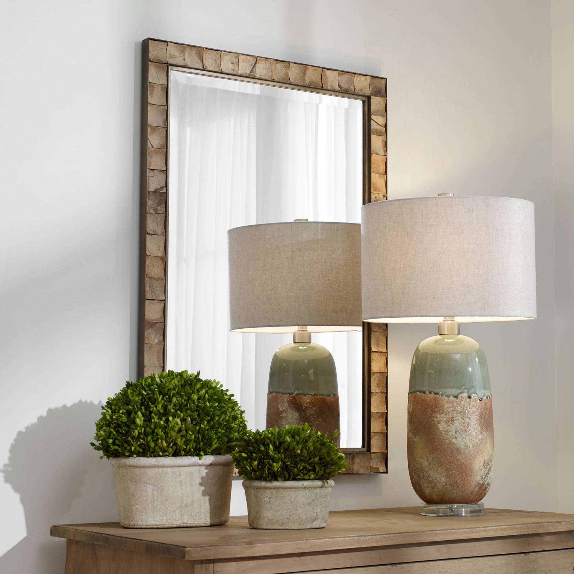 Cocos Mirror by Uttermost in dark gold. Made from iron, glass coconut shell, mdf in a transitional style.