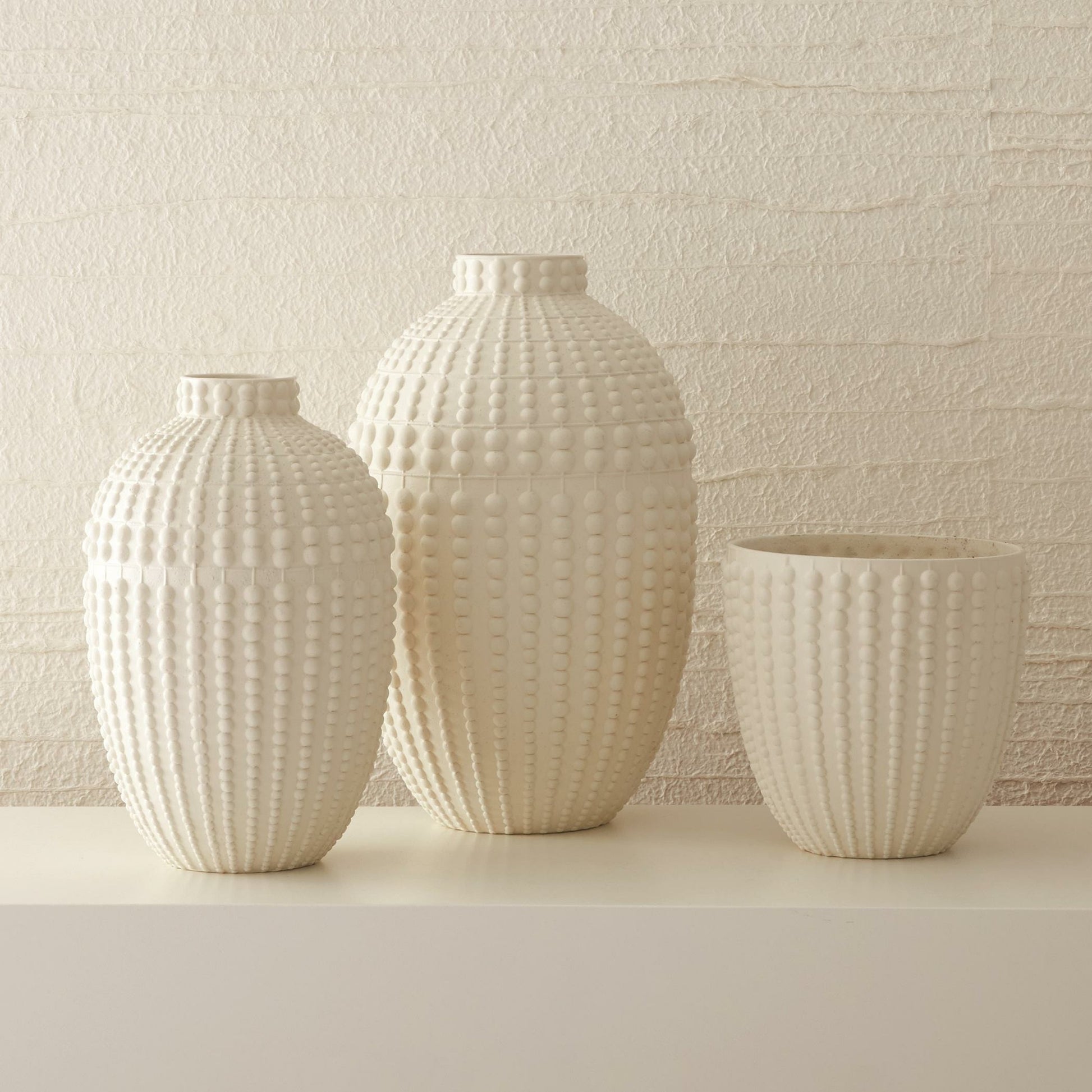 Nail Head Vase by Global Views in rustic white. Made from ceramic in a coastal style.