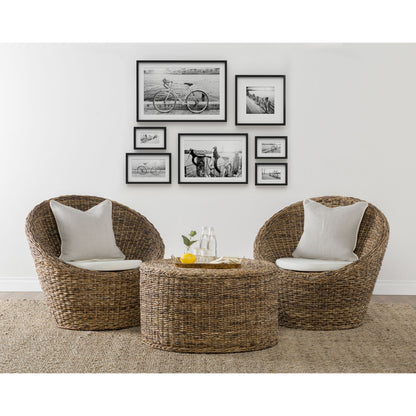 Ira Round Rattan Coffee Table by Kosas Home. Made from rattan abaca in a coastal style.