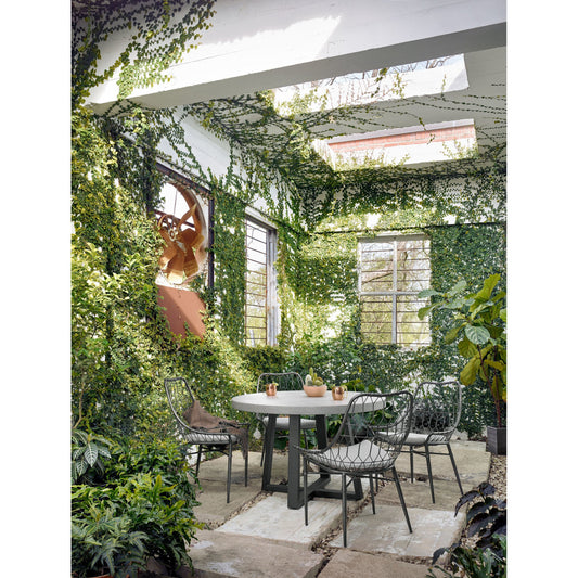 Cyrus Outdoor Round Dining Table by Four Hands. Made from lavastone composite, iron in a modern style.