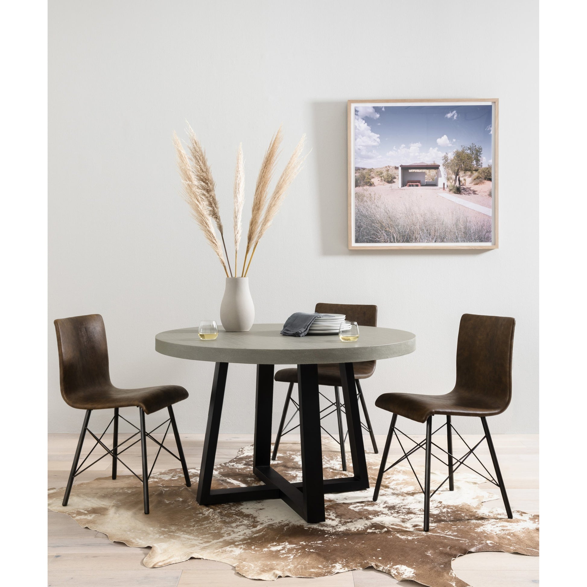 Cyrus Outdoor Round Dining Table by Four Hands. Made from lavastone composite, iron in a modern style.
