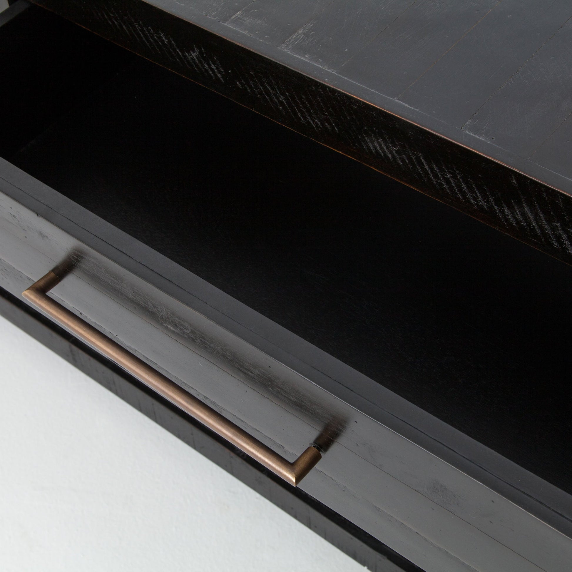 Suki Console Table by Four Hands in burnished black. Made from resawn mixed wood in a modern style.