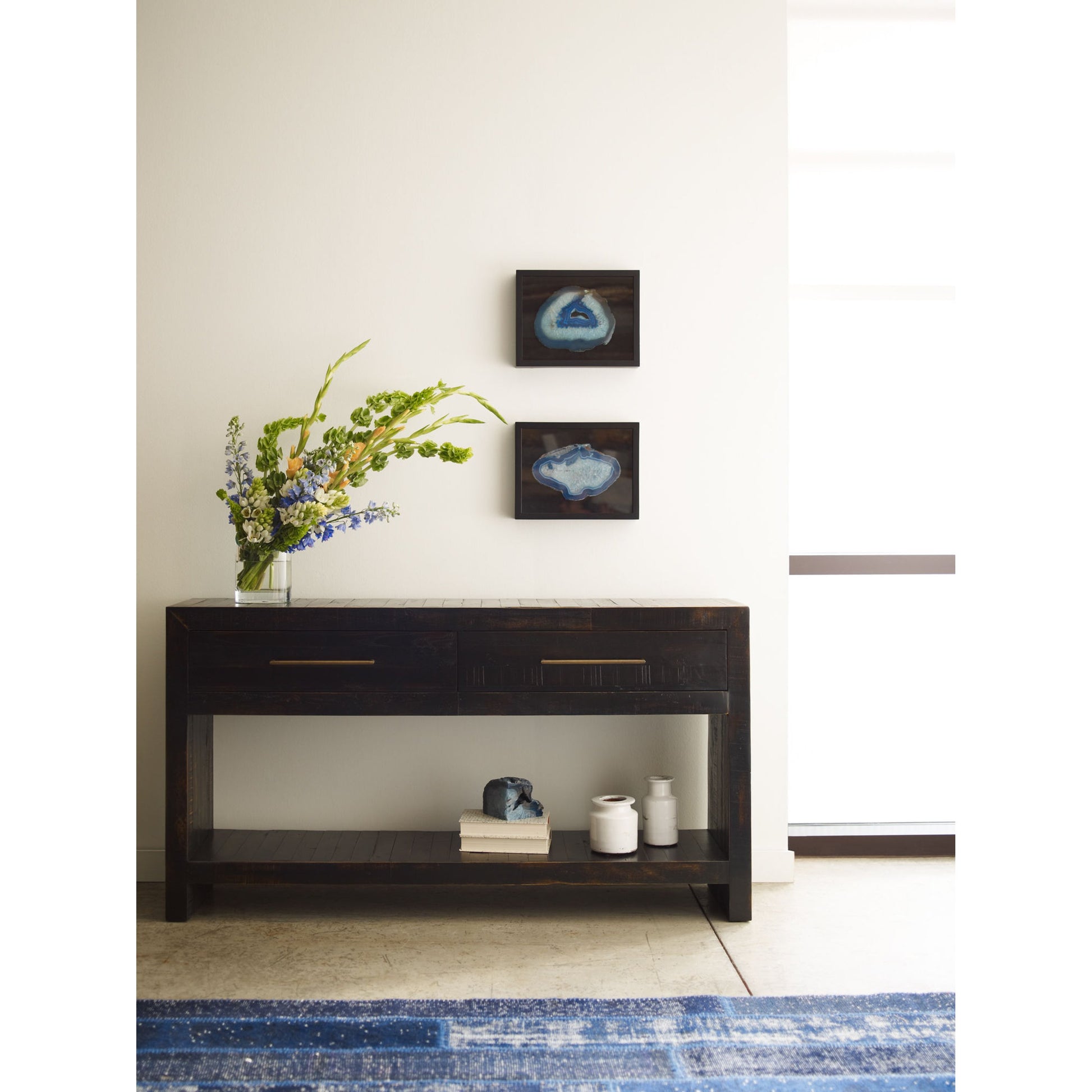 Suki Console Table by Four Hands in burnished black. Made from resawn mixed wood in a modern style.
