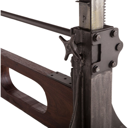 Welles Adjustable Dining Table by World Interiors in brown and weathered russet, gunmetal. Made from teak wood, cast iron in a modern style.