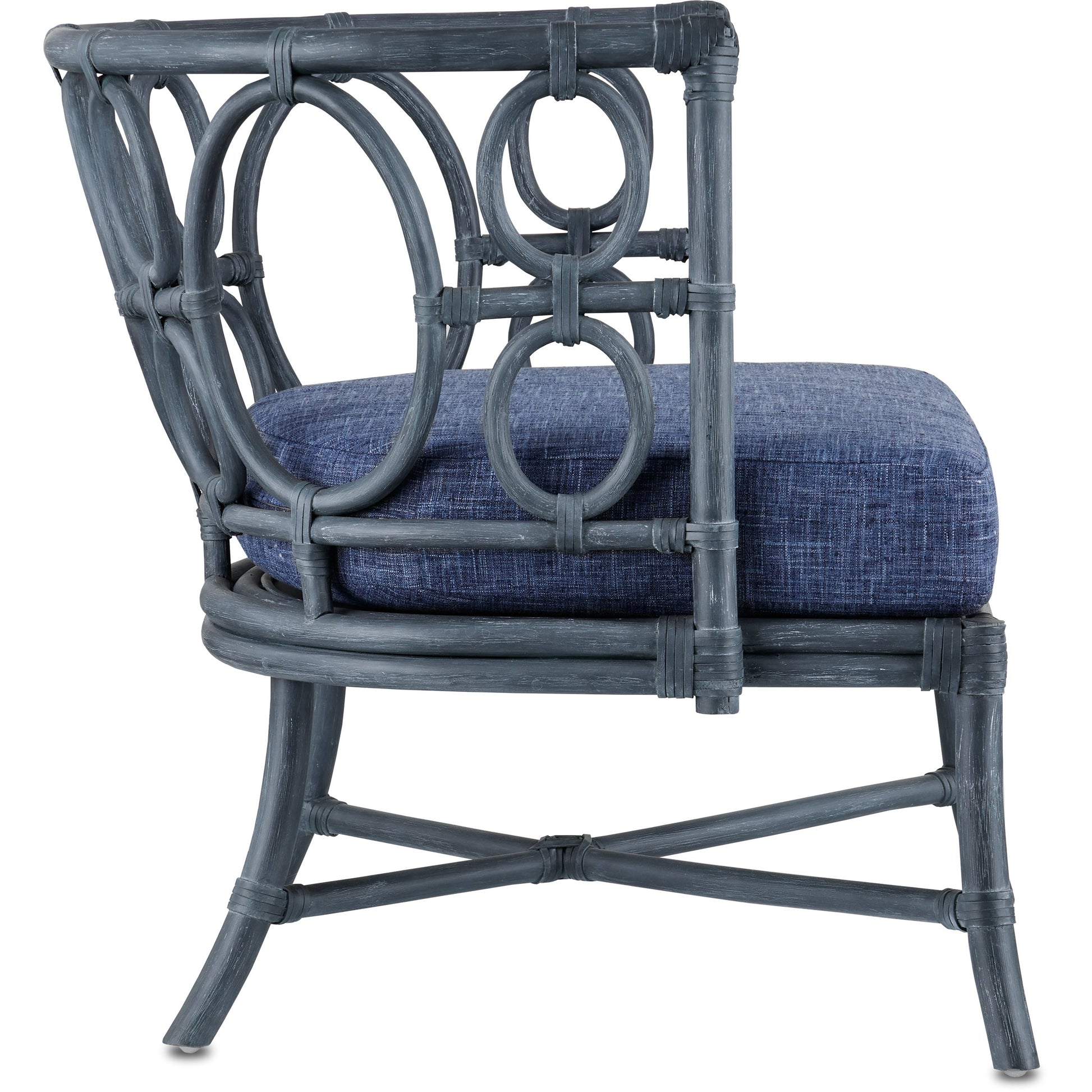 Tegal Chair by Currey and Company in vintage navy, indigo. Made from rattan, plywood, fabric, foam in a coastal style.