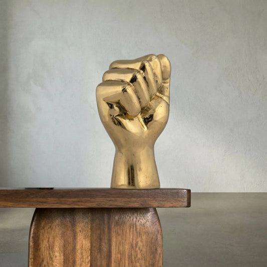 The Solidarity Fist by Noir in brass. Made from brass in a modern style.
