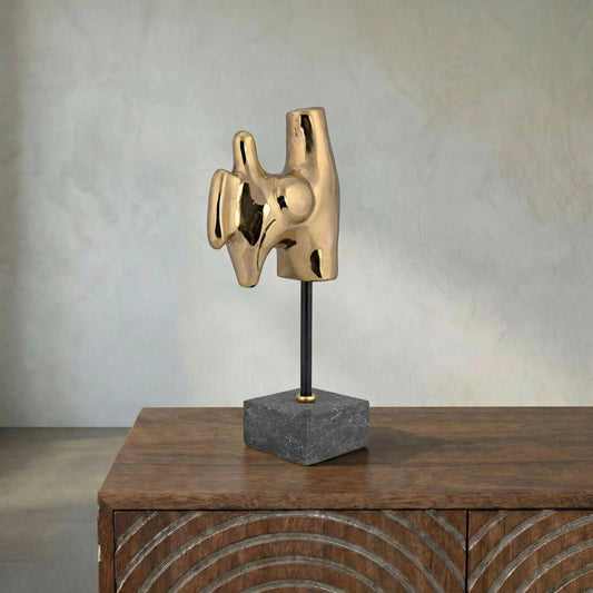 Goker by Noir in antique brass. Made from metal alloy with black marble base in a modern style.