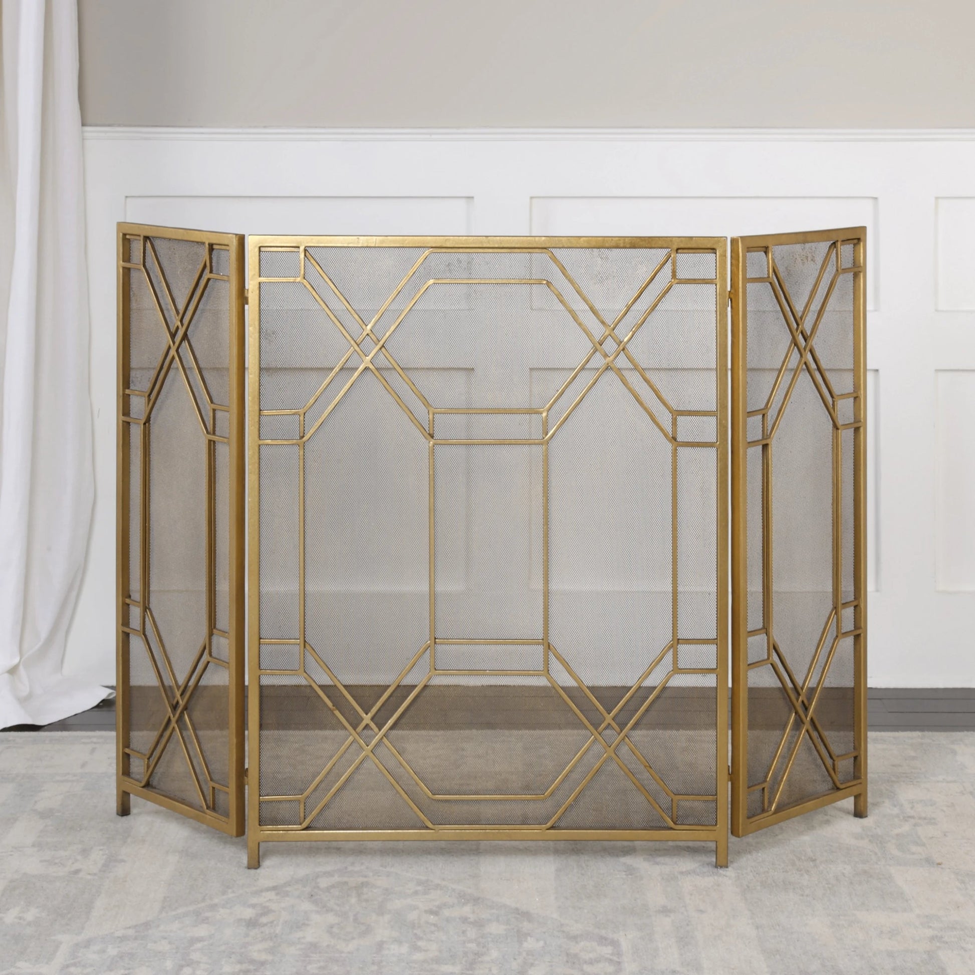 Rosen Fireplace Screen by Uttermost in gold. Made from metal in a traditional style.