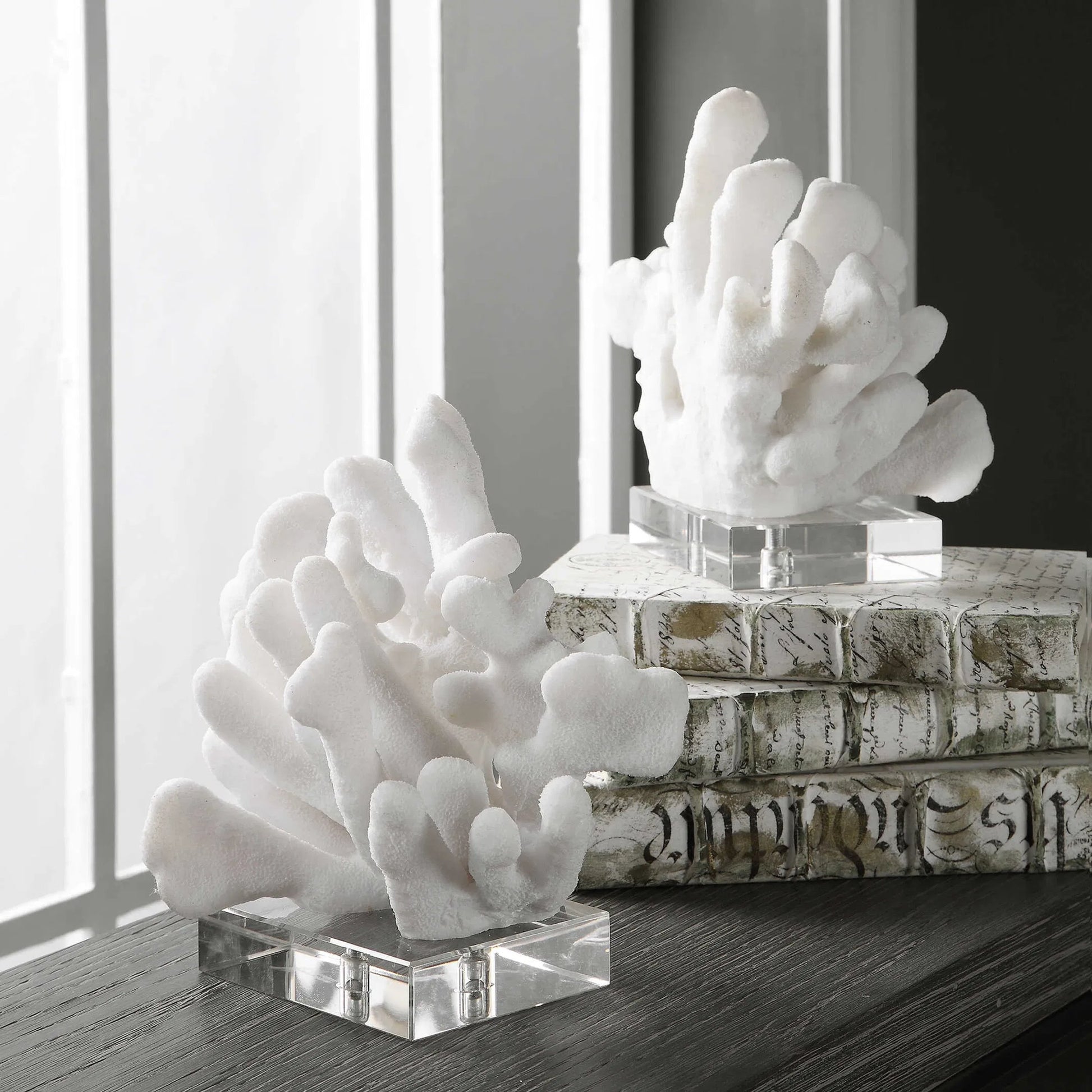 Charbel Bookends by Uttermost in white. Made from resin, k9cystal in a coastal style.