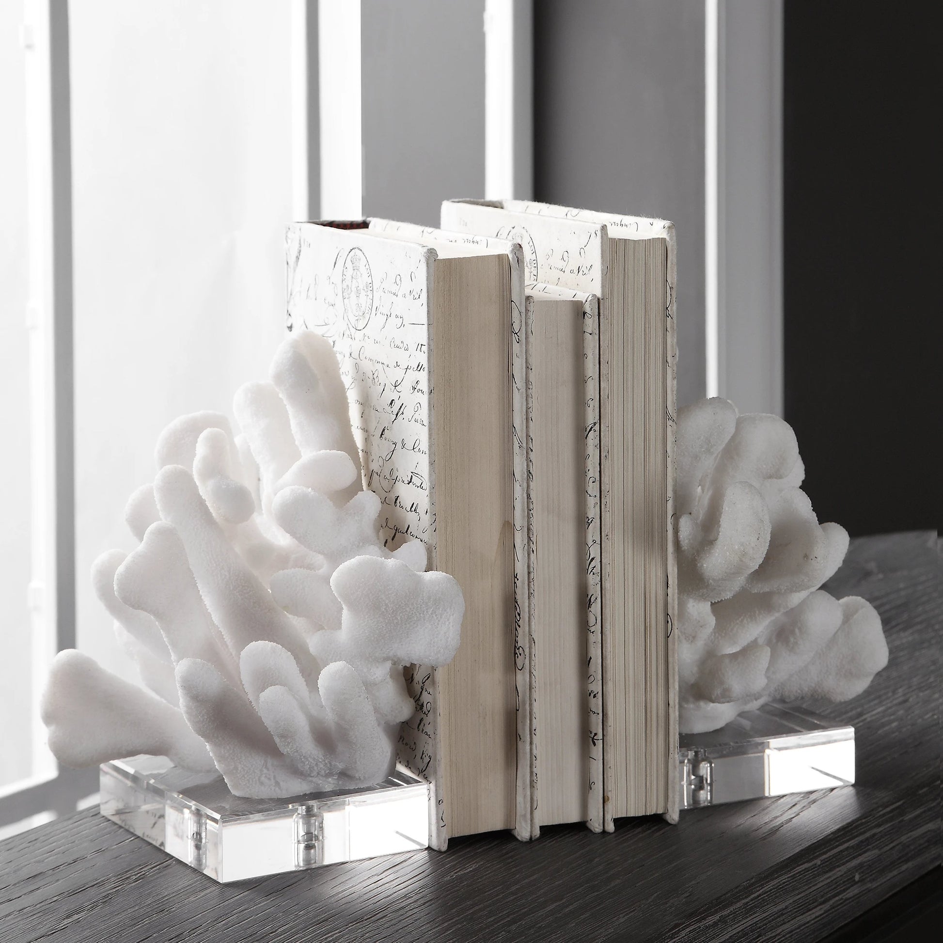 Charbel Bookends by Uttermost in white. Made from resin, k9cystal in a coastal style.