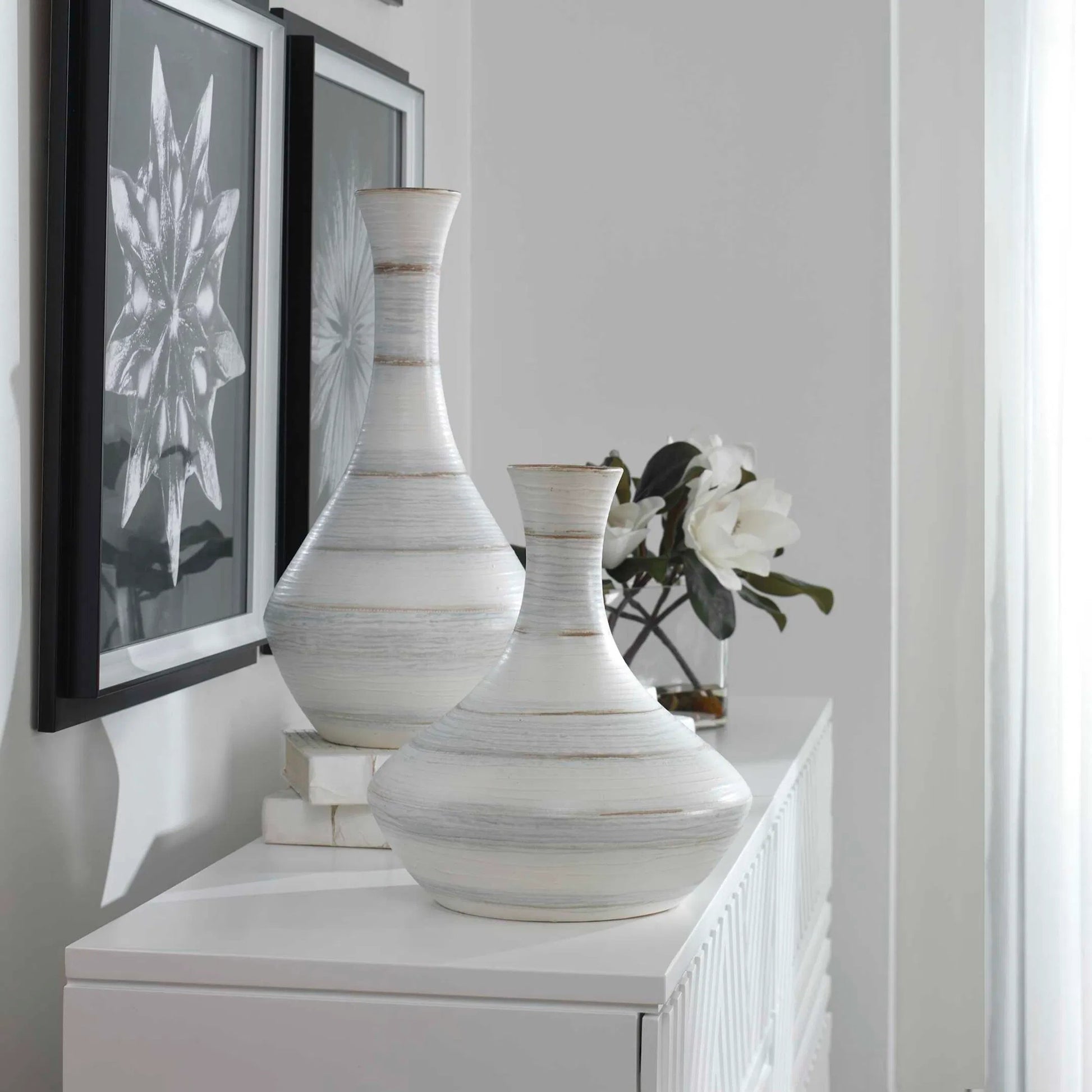 Potter Vases by Uttermost in ivory. Made from earthenware in a traditional style.