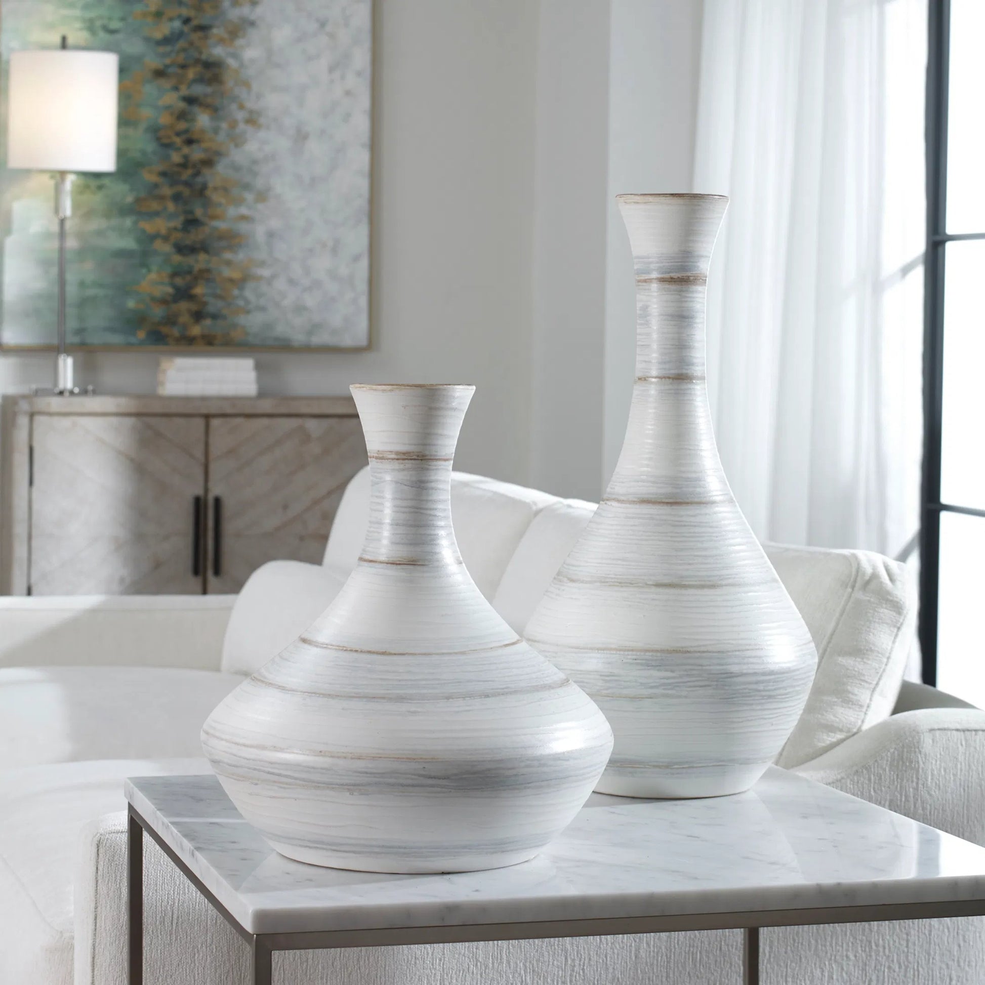 Potter Vases by Uttermost in ivory. Made from earthenware in a traditional style.